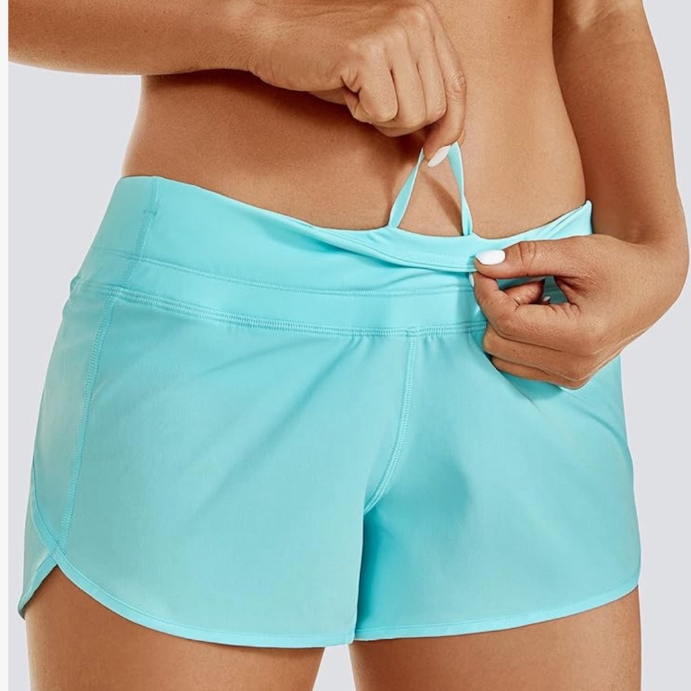 Women’s aqua athletic shorts with zip pocket and mesh liner size M and NWOT